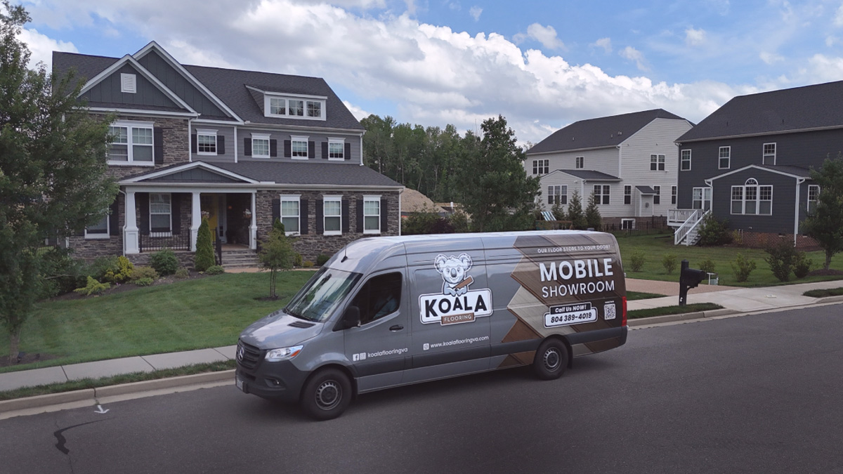 Koala Flooring mobile showroom van parked in front of a house